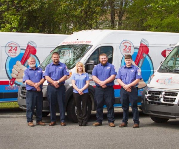 a group of people standing in front of a truck